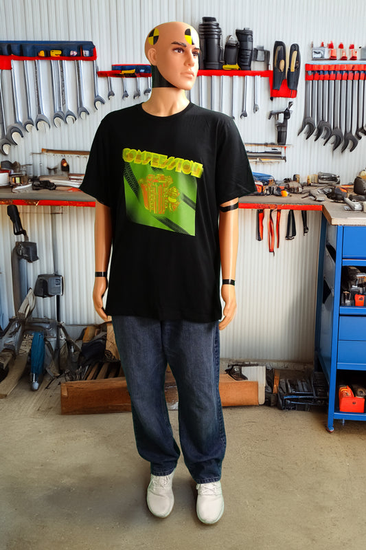 Crash test dummy mannequin in a workshop setting wearing a black t-shirt with a green, orange, and yellow illustration of a JDM engine with a big turbo charger from the top and stylized text that says Compression Obsession on the front.