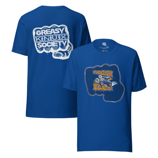 Blue t-shirt with orange and blue illustration of a retro coupe with a small engine and a giant turbo charger spinning it's wheels in front of a brick wall with a crash test dummy driving and graffiti styled text that reads Displacement Replacement on the front.
On the back is a large white logo consisting of big fist with brass knuckles and bandage on the thumb with type reading Greasy Knux Society. Greasy and Society are stylized to look like dripping grease and Knux is made of various tools.