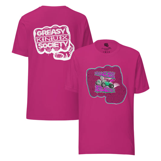 Pink t-shirt with pink and teal illustration of a retro coupe with a small engine and a giant turbo charger spinning it's wheels in front of a brick wall with a crash test dummy driving and graffiti styled text that reads Displacement Replacement on the front.
On the back is a large white logo consisting of big fist with brass knuckles and bandage on the thumb with type reading Greasy Knux Society. Greasy and Society are stylized to look like dripping grease and Knux is made of various tools.